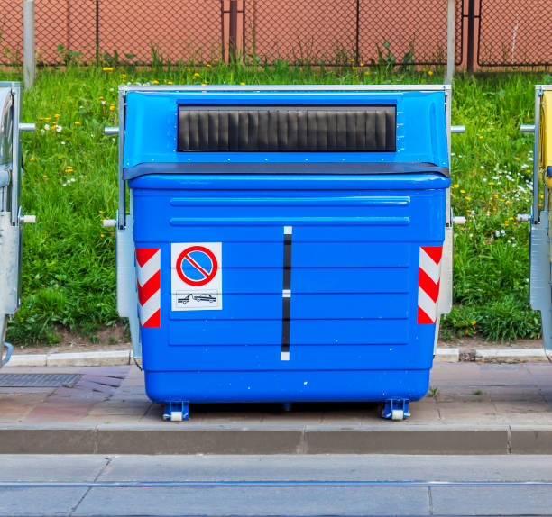 blue recycling container on the street